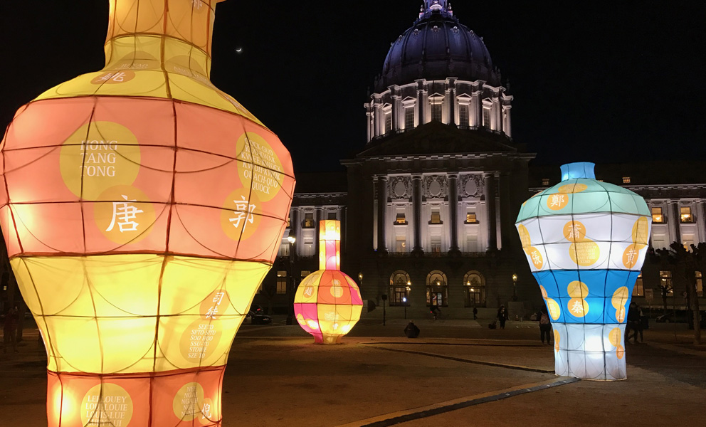 Three colorful large scale lanterns in front of SF City Hall at night.