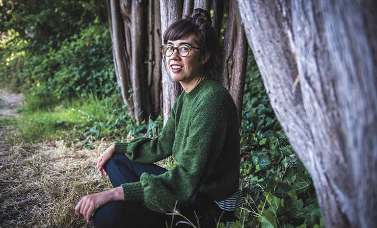 the artist sitting under a tree