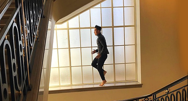 Ensemble Member Hien Huynh image of man dancing on window ledge.