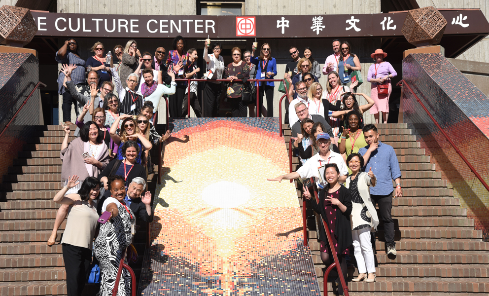 A group of people standing by a mosaic staircase in front of the Chinese Culture Center
