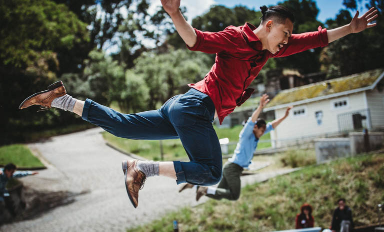 Male dancers leaping through the air