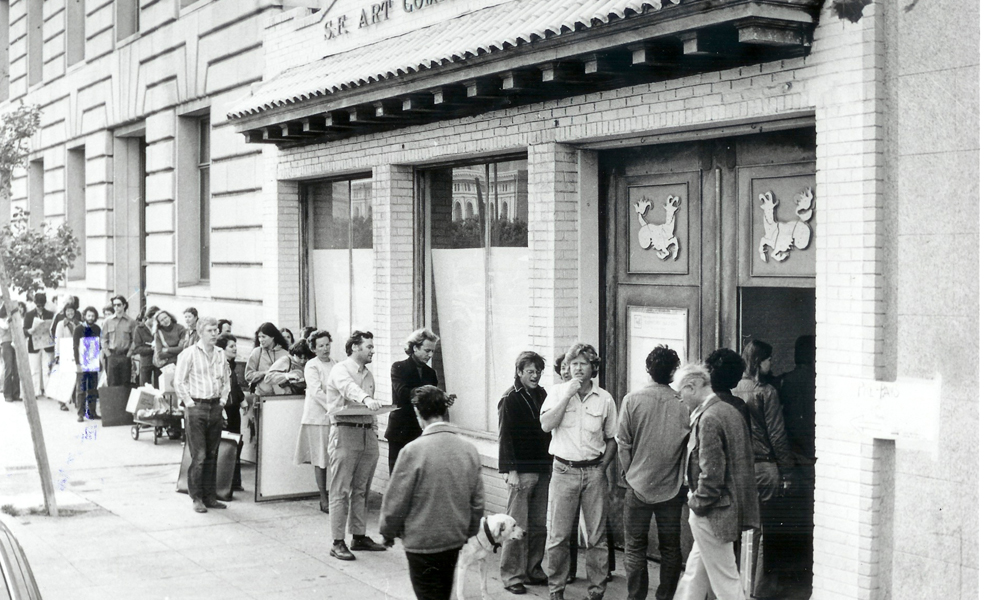 Archival photograph of 155 Grove Street in the 70s. Images shows the storefront with a line of people waiting to get in.