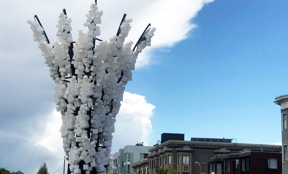 Large light sculpture comprised of white boxes that illuminate at night.