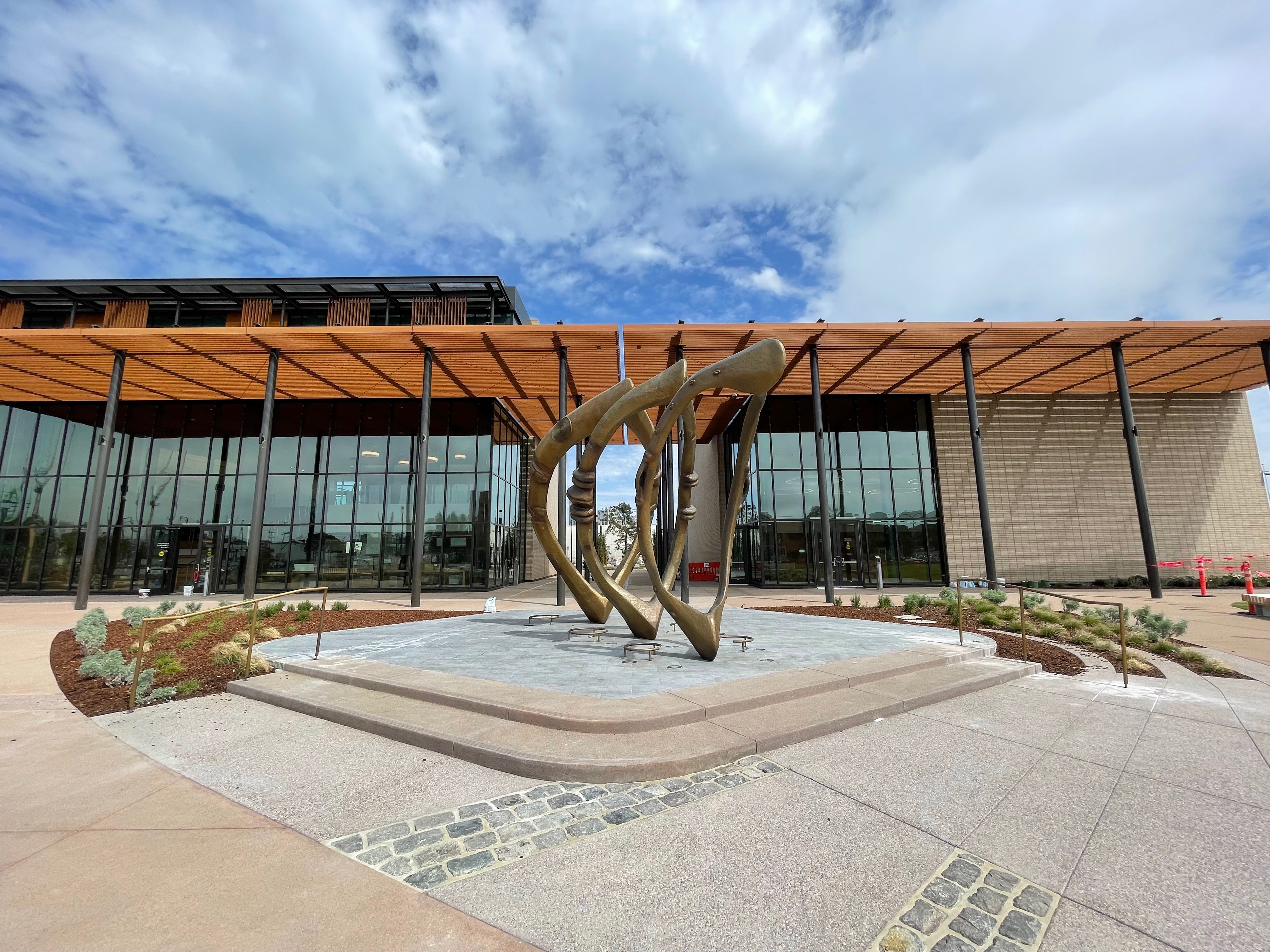 Image of three bronze sculptures by Mildred Howard in front of the Southeast Community Center