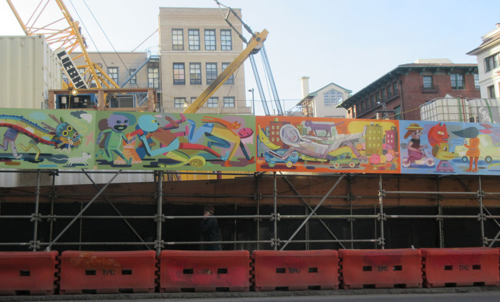 Colorful mural by Jason Jagel on the construction barrier at the new Chinatown Centeral Subway station 