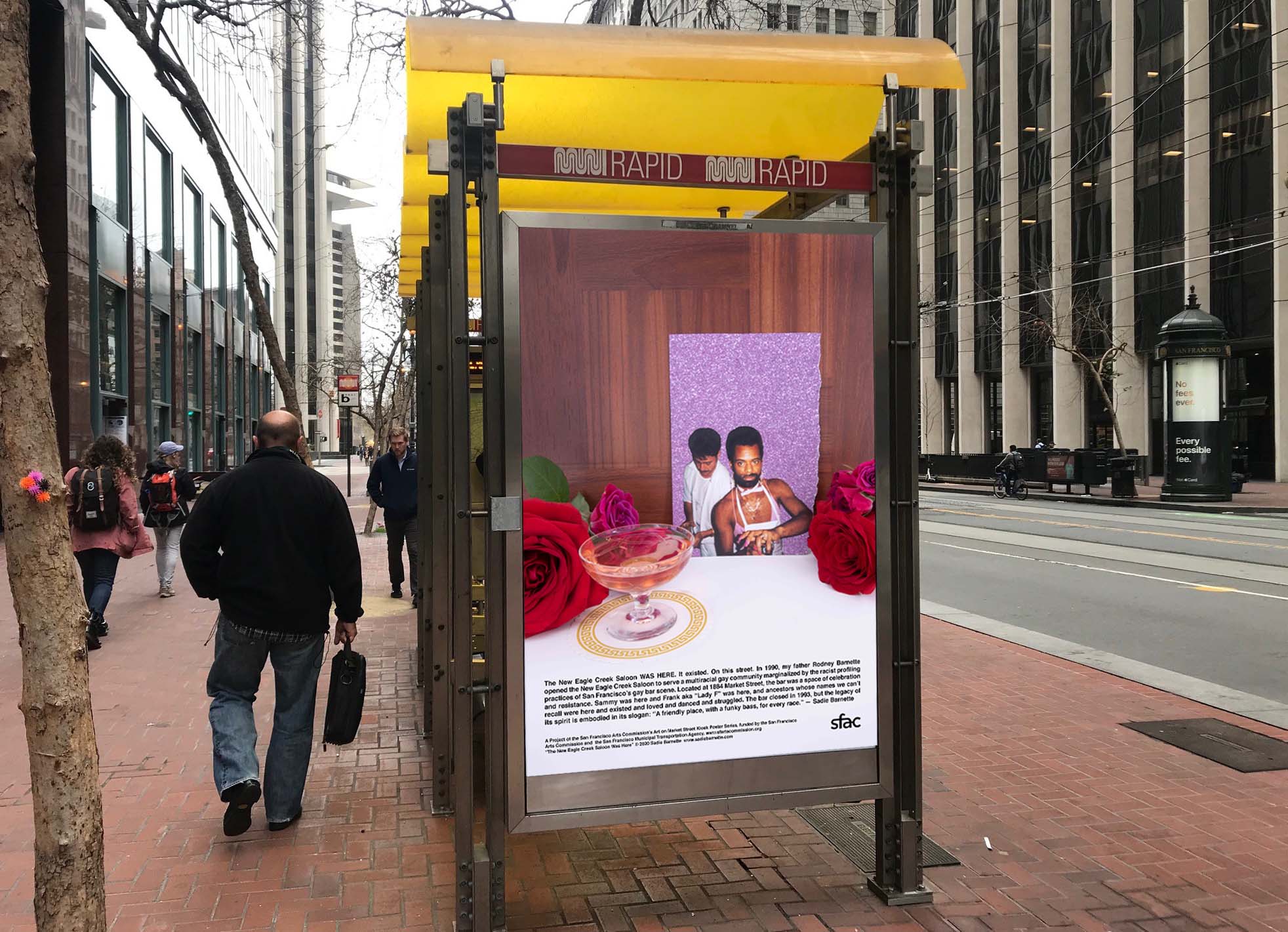 Muni bus shelter with man walking on Market street