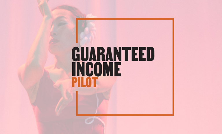 A faded image, tinted red, of a female dancer. Overlaid over the image is the text "guaranteed income pilot."