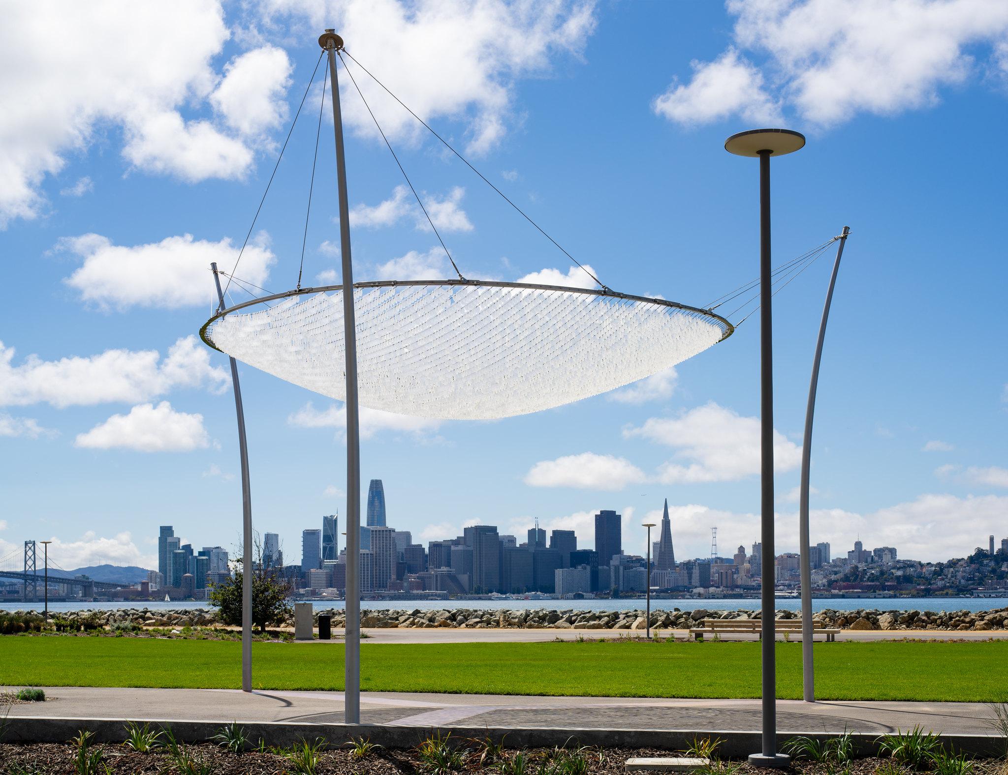 Image: View of San Francisco City Skyline and Canopy of Sky by Ned Kahn at Cityside Park on Treasure Island. Photo by Ethan Kaplan Photography.